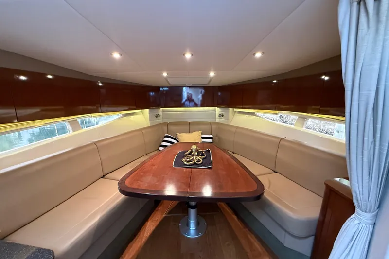  Yacht Photos Pics Luxurious interior of 2014 Sea Ray 370 Venture yacht with elegant seating and wooden table.