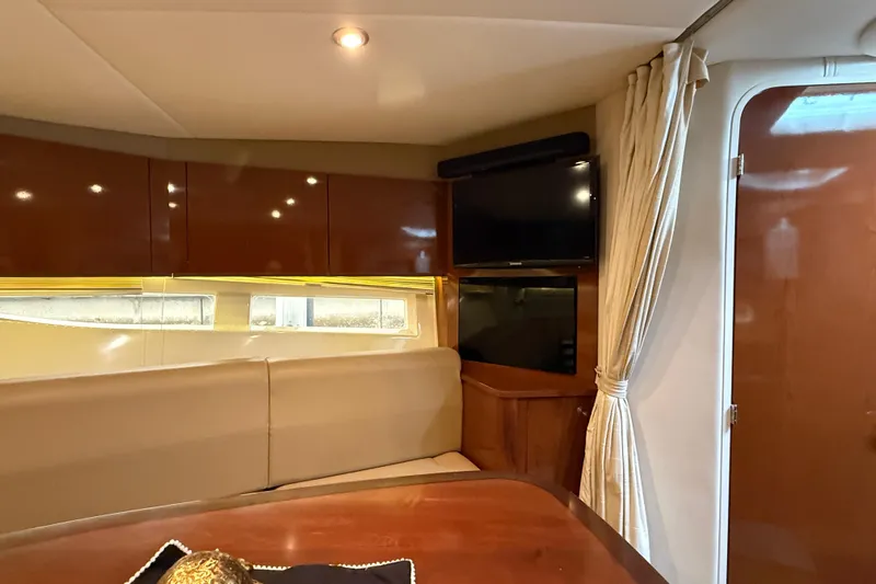  Yacht Photos Pics Interior of 2014 Sea Ray 370 Venture yacht with seating, TV, and wooden cabinetry.