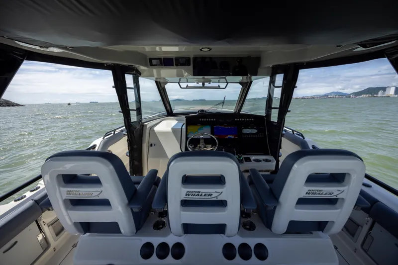 Pachanga Yacht Photos Pics Interior view of 2021 Boston Whaler 420 Outrage boat cockpit with ocean backdrop.