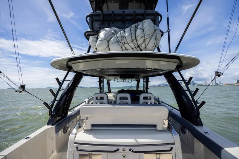 Pachanga Yacht Photos Pics 2021 Boston Whaler 420 Outrage boat on water, showcasing helm and seating area.