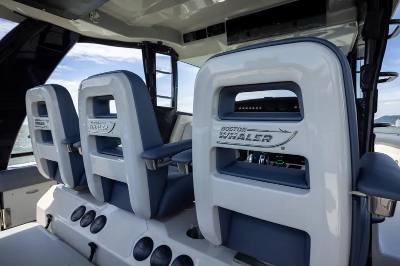 Pachanga Yacht Photos Pics 2021 Boston Whaler 420 Outrage helm seats with logo, showcasing luxury marine design.