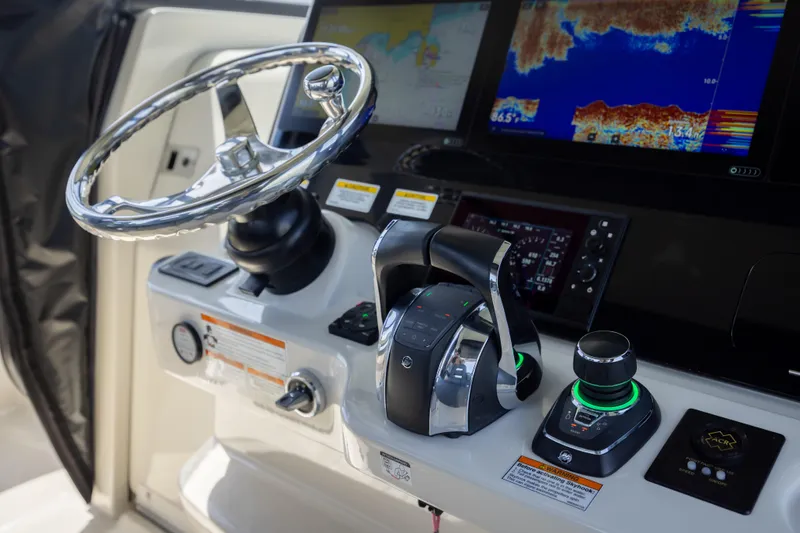 Pachanga Yacht Photos Pics Control panel of 2021 Boston Whaler 420 Outrage with steering wheel and navigation screens.