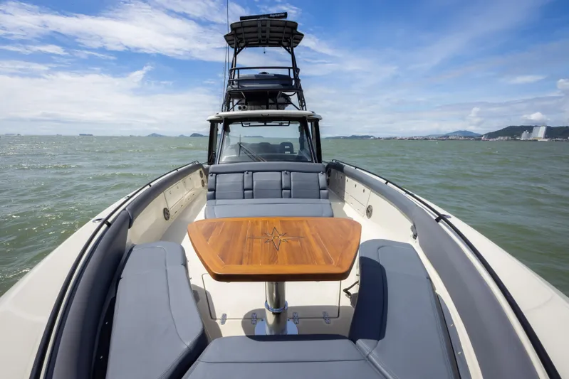 Pachanga Yacht Photos Pics 2021 Boston Whaler 420 Outrage boat with elegant seating and wooden table on open water.