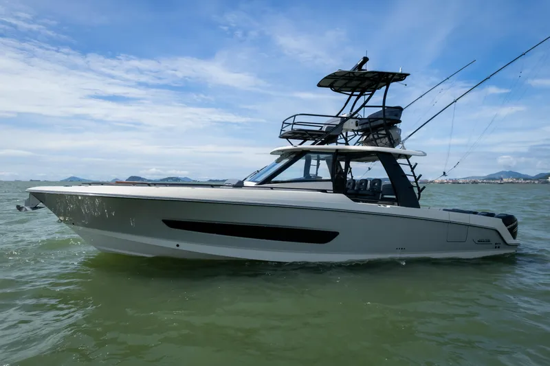 Pachanga Yacht Photos Pics 2021 Boston Whaler 420 Outrage boat on calm water under a clear blue sky.