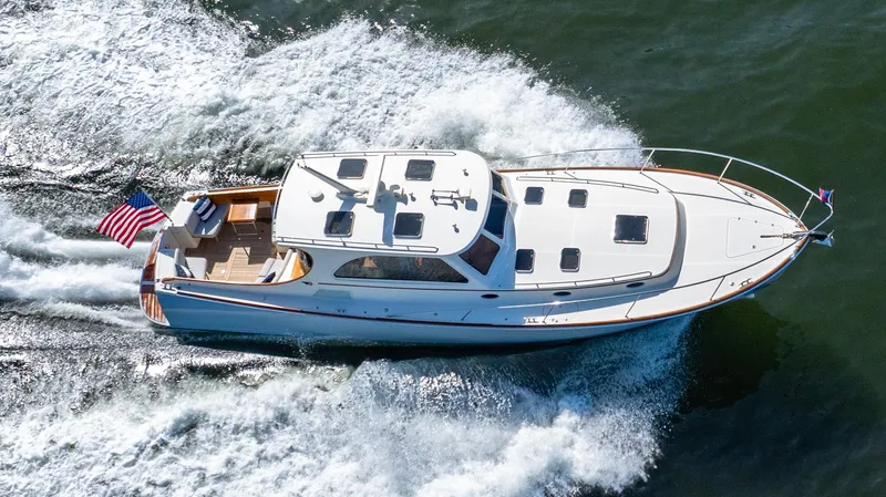 Skylark Yacht Photos Pics 2008 Hinckley Talaria 44 yacht cruising on open water, displaying sleek design and American flag.