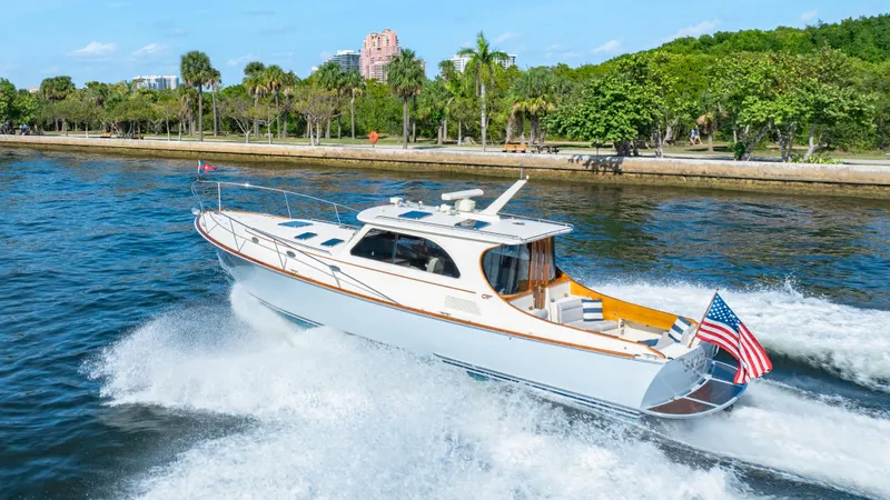 Skylark Yacht Photos Pics 2008 Hinckley Talaria 44 yacht cruising on a scenic waterway with lush greenery.