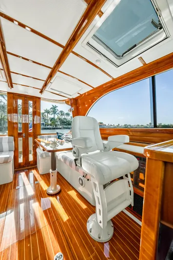 Skylark Yacht Photos Pics Luxurious interior of 2008 Hinckley Talaria 44 yacht with polished wood and white seating.