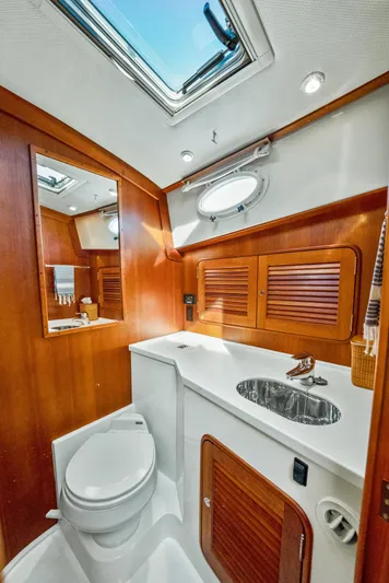 Skylark Yacht Photos Pics Luxurious 2008 Hinckley Talaria 44 yacht bathroom with wood accents and modern fixtures.