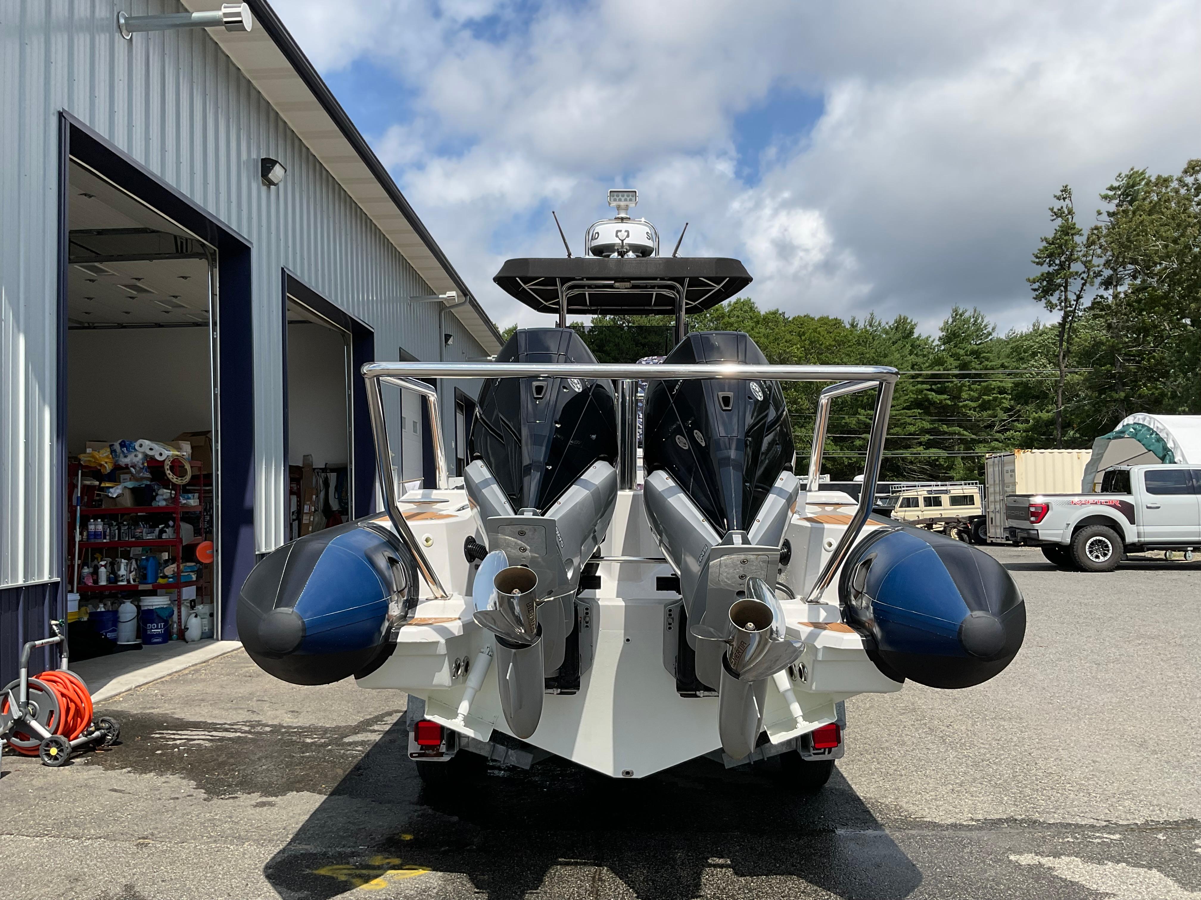 2019 Protector 310 Chase boat with dual engines at a marina.