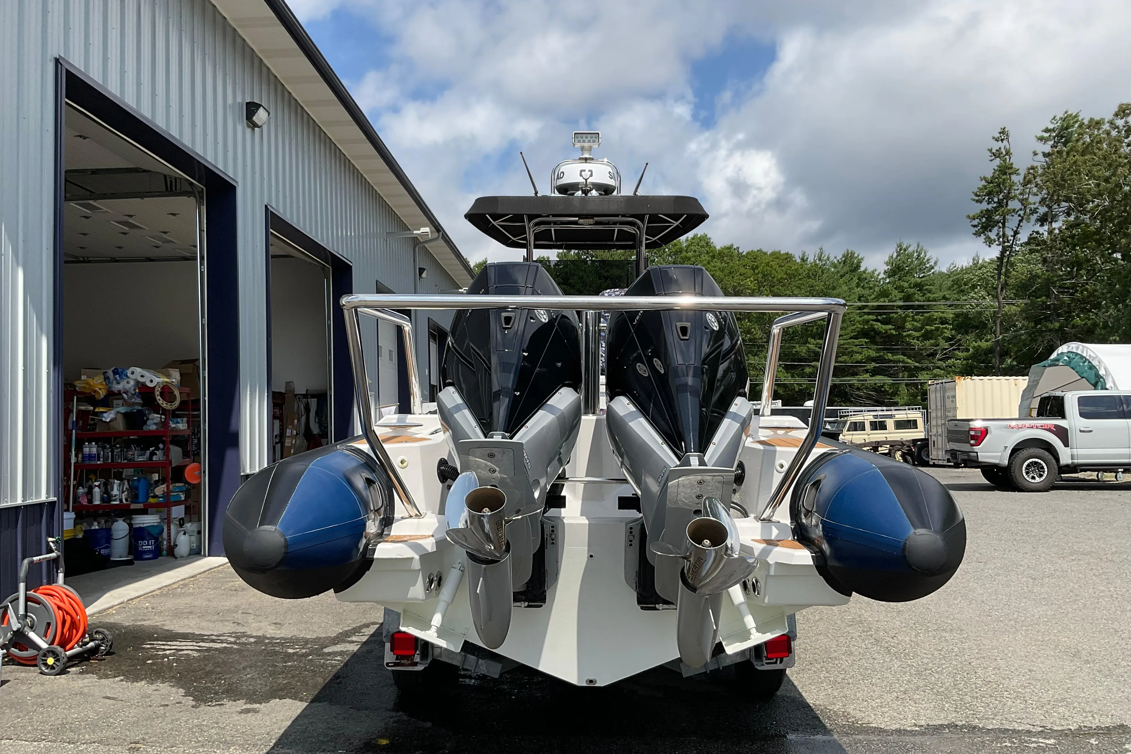 2019 Protector 310 Chase boat with dual engines at a marina.