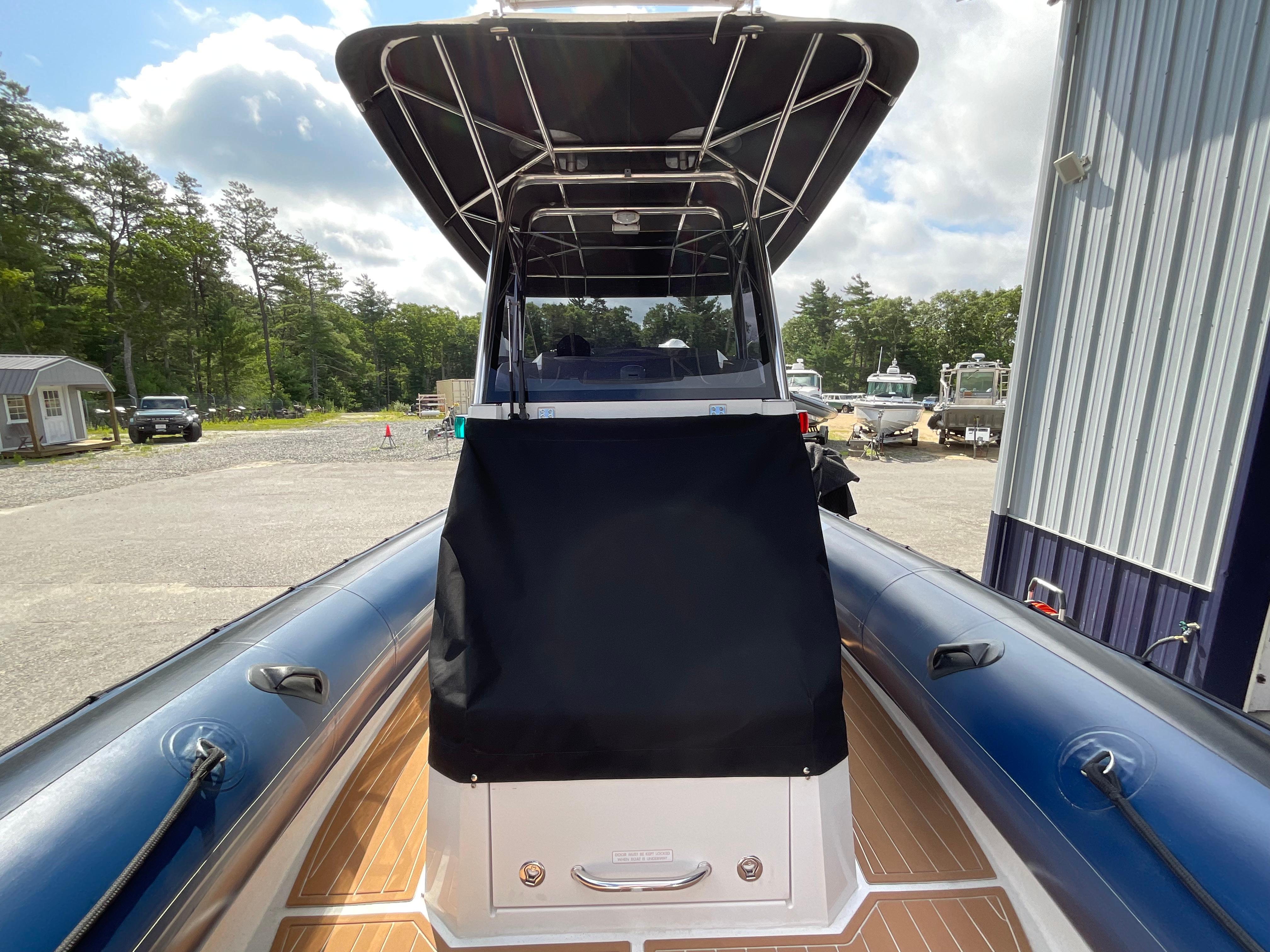2019 Protector 310 Chase boat with canopy, docked outdoors on a sunny day.