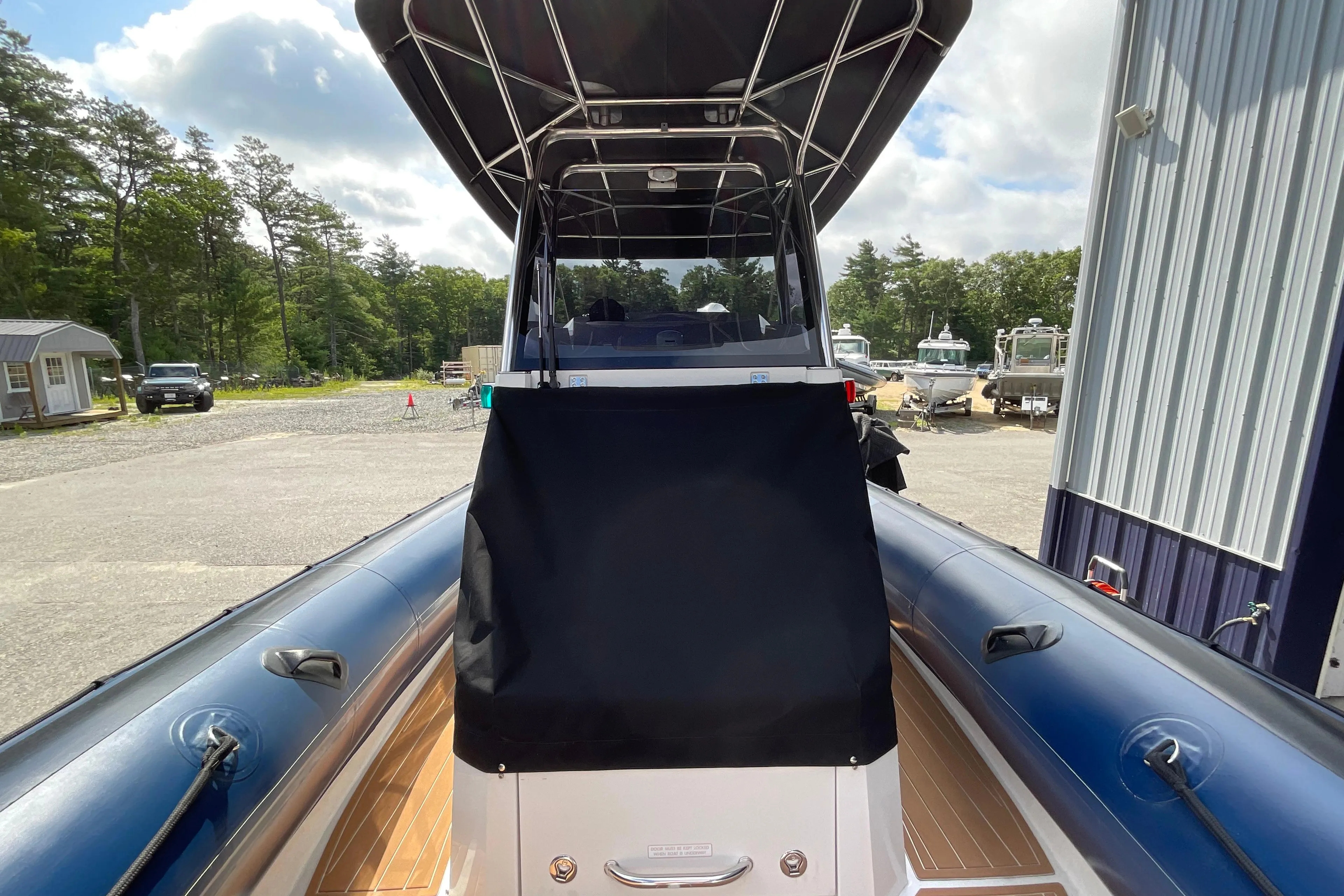 2019 Protector 310 Chase boat with canopy, docked outdoors on a sunny day.