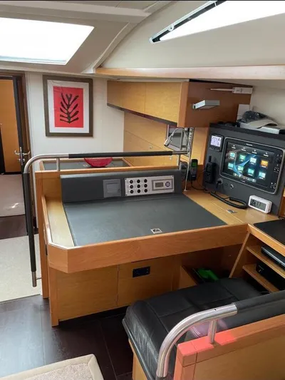 4850 Yacht Photos Pics Navigation station inside 2013 CNB BORDEAUX 60 yacht with modern controls and wood finish.