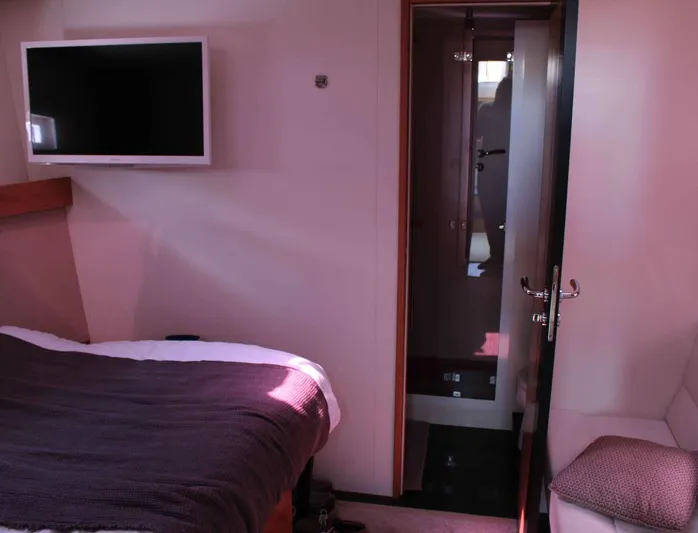 4850 Yacht Photos Pics Luxurious cabin interior of 2013 CNB BORDEAUX 60 yacht with bed, TV, and ensuite bathroom.