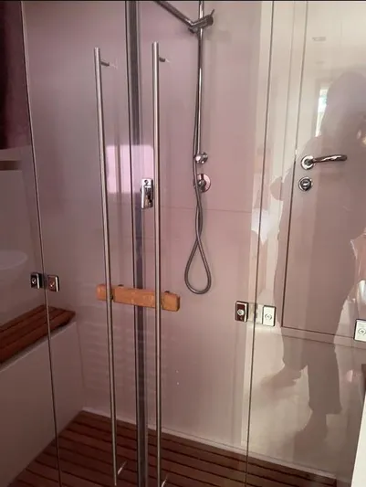 4850 Yacht Photos Pics Luxurious shower area in 2013 CNB BORDEAUX 60 yacht with glass doors and wooden accents.