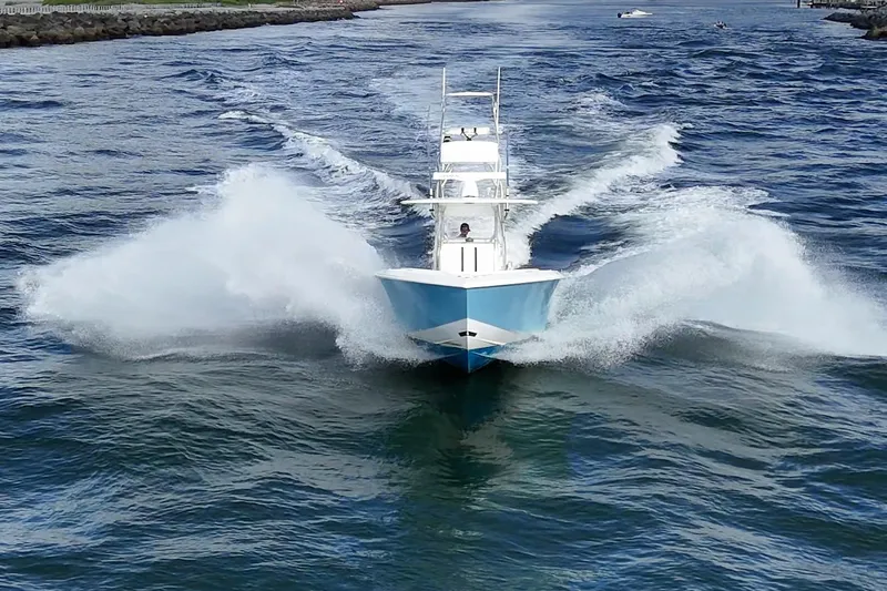 Poliseas Yacht Photos Pics 2006 Bahama 31 boat cruising through ocean waves, creating a dynamic water splash.