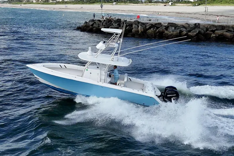 Poliseas Yacht Photos Pics 2006 Bahama 31 boat cruising in open water near rocky shoreline.