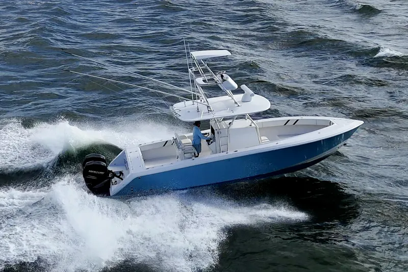 Poliseas Yacht Photos Pics 2006 Bahama 31 boat navigating through ocean waves, featuring a sleek blue hull.