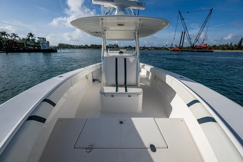 Poliseas Yacht Photos Pics 2006 Bahama 31 boat on water, clear sky, and distant cranes.