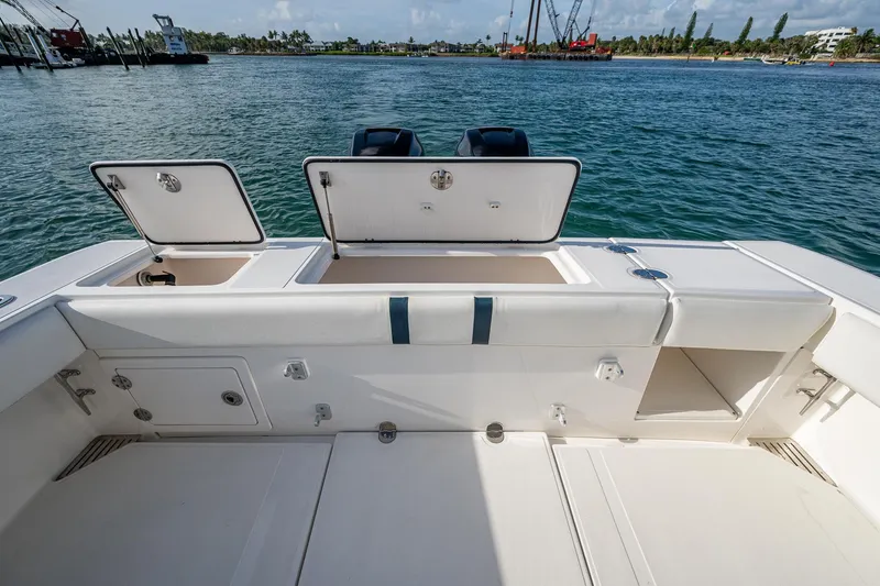 Poliseas Yacht Photos Pics 2006 Bahama 31 boat deck with open storage compartments, docked by the water.