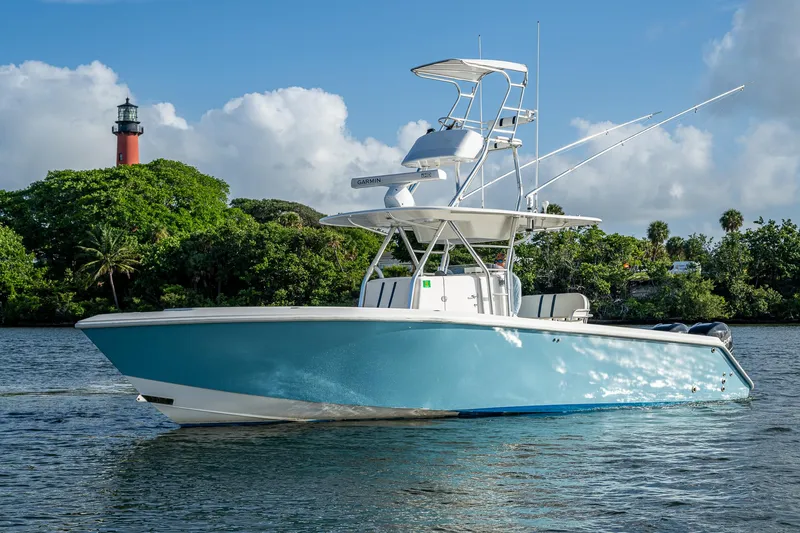 Poliseas Yacht Photos Pics 2006 Bahama 31 boat on water near a lighthouse and lush greenery.
