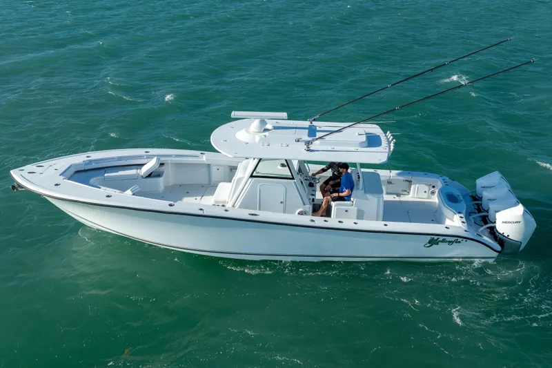  Yacht Photos Pics 2022 Yellowfin 39 Offshore boat cruising on open water, featuring dual outboard engines.