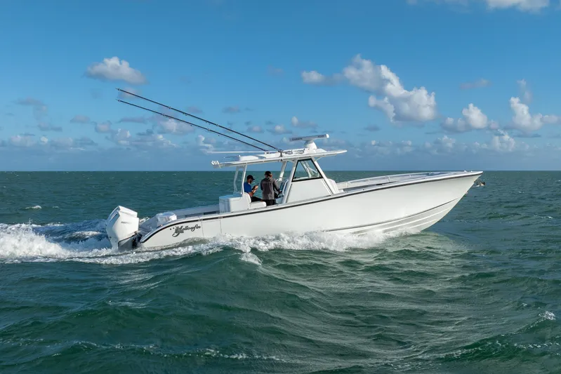  Yacht Photos Pics 2022 Yellowfin 39 Offshore boat cruising on open water under a clear blue sky.