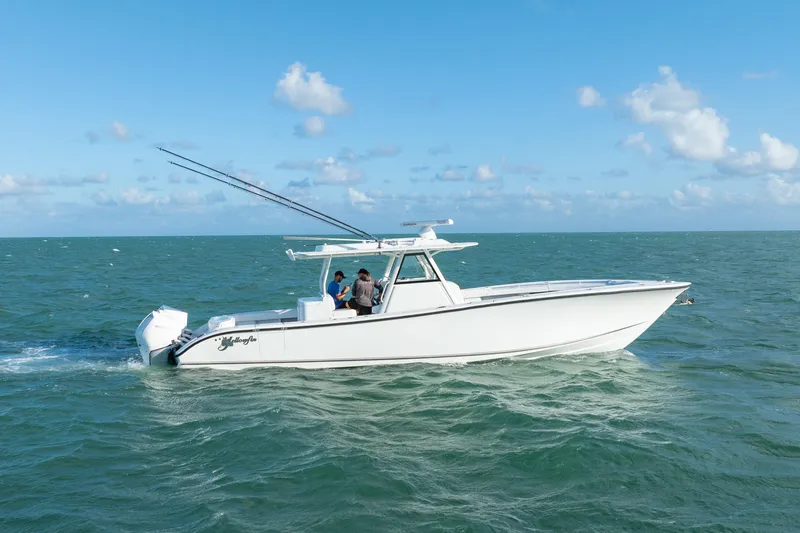  Yacht Photos Pics 2022 Yellowfin 39 Offshore boat cruising on open sea under clear blue sky.
