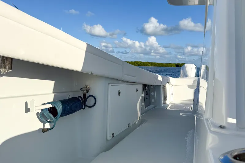  Yacht Photos Pics 2022 Yellowfin 39 Offshore boat deck with coiled hose, sunny day, blue sky.