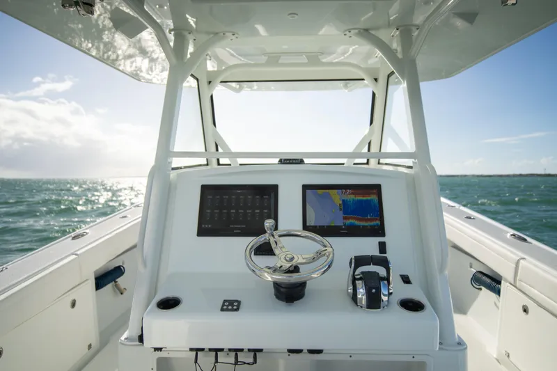  Yacht Photos Pics 2022 Yellowfin 39 Offshore boat console with dual screens on open water.