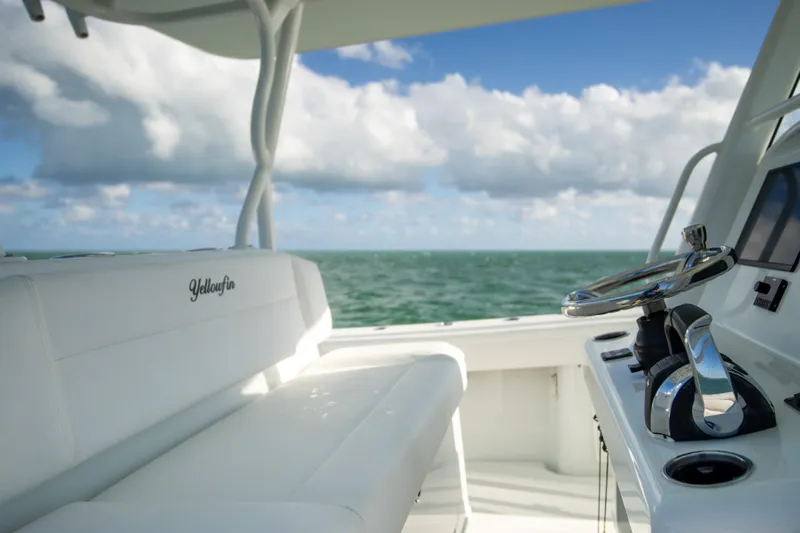  Yacht Photos Pics 2022 Yellowfin 39 Offshore boat interior with ocean view and steering wheel.