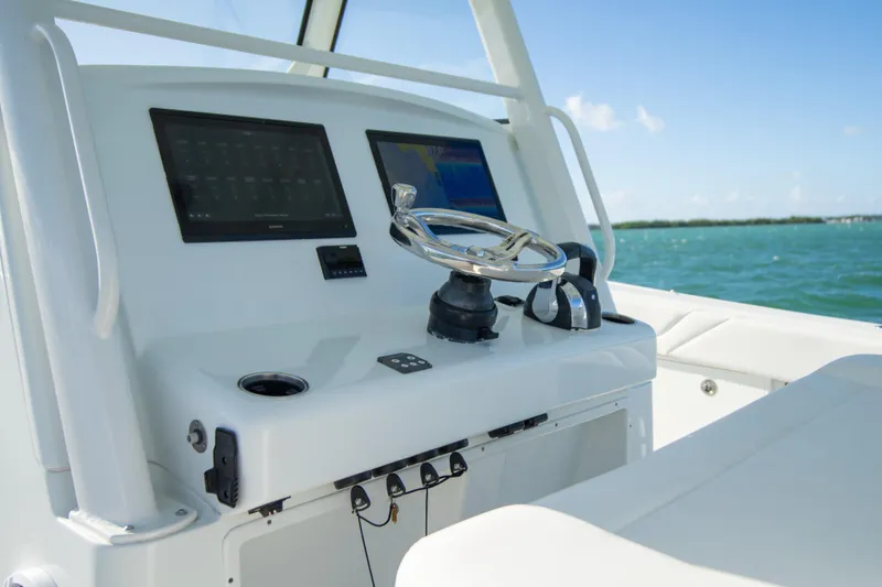  Yacht Photos Pics 2022 Yellowfin 39 Offshore boat helm with dual screens and steering wheel.
