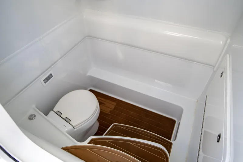  Yacht Photos Pics 2022 Yellowfin 39 Offshore boat bathroom with wooden flooring and modern toilet.