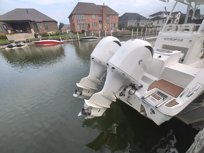  Yacht Photos Pics 2017 Sea Fox 328 Commander with dual outboard engines docked in a residential marina.