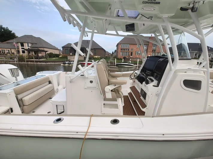  Yacht Photos Pics 2017 Sea Fox 328 Commander boat interior with helm, seating, and waterfront view.