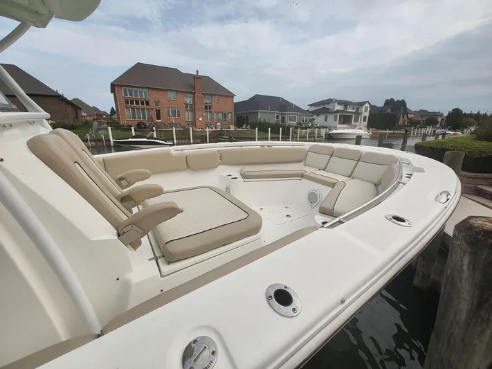  Yacht Photos Pics 2017 Sea Fox 328 Commander boat with spacious seating, docked near waterfront homes.