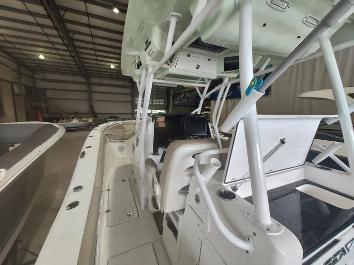  Yacht Photos Pics 2017 Sea Fox 328 Commander boat interior with helm and seating in a storage facility.