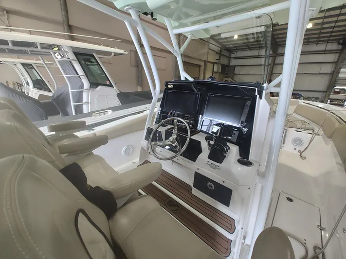  Yacht Photos Pics 2017 Sea Fox 328 Commander boat interior with dual screens and steering wheel in a spacious cabin.