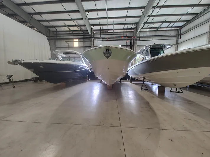  Yacht Photos Pics 2017 Sea Fox 328 Commander boat in storage, flanked by two other boats.