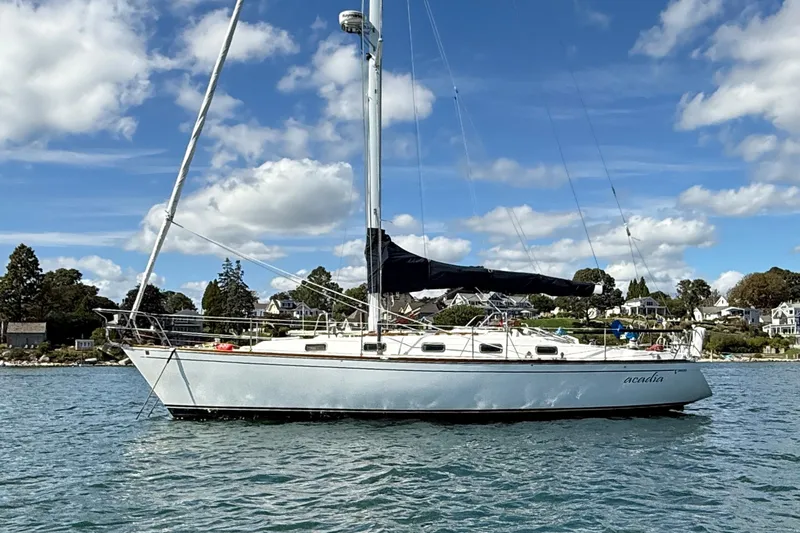 Acadia Yacht Photos Pics Sailboat Tartan 3800, 1997 model, anchored on a sunny day with scenic background.
