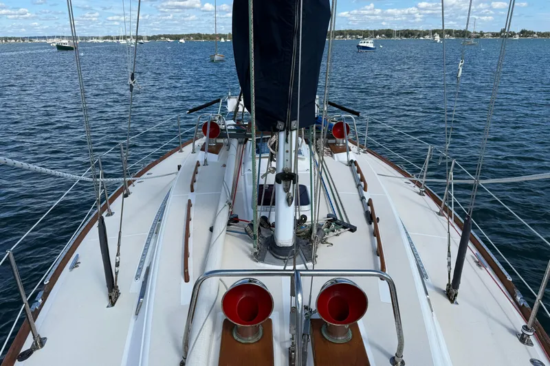 Acadia Yacht Photos Pics Sailboat deck view of 1997 Tartan 3800 on calm waters under blue sky.