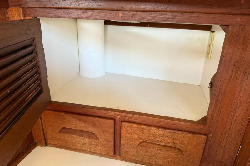 Acadia Yacht Photos Pics Wooden cabinet interior with paper towel roll, Tartan 3800, 1997 model.