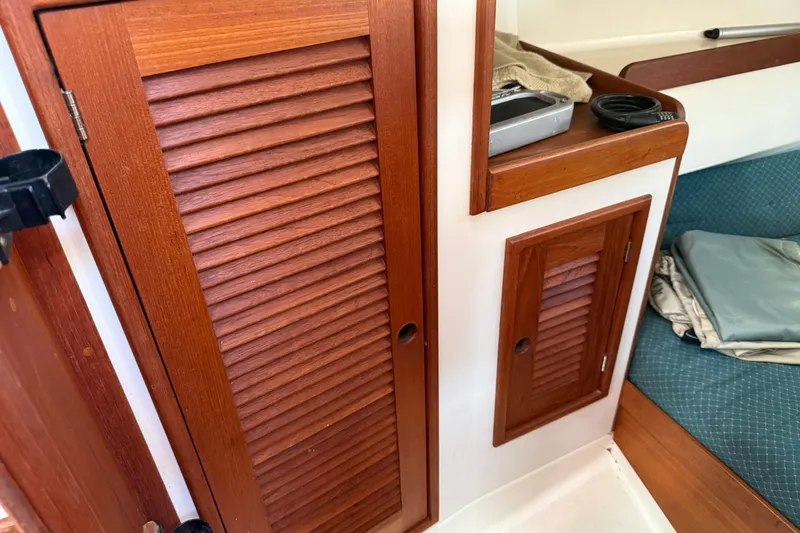 Acadia Yacht Photos Pics Wooden cabinets and seating area inside a 1997 Tartan 3800 sailboat interior.