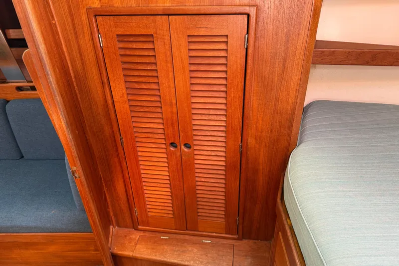 Acadia Yacht Photos Pics Wooden interior of 1997 Tartan 3800 sailboat with louvered cabinet doors.