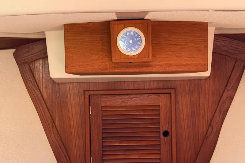 Acadia Yacht Photos Pics Wooden interior of a 1997 Tartan 3800 sailboat with a nautical clock.