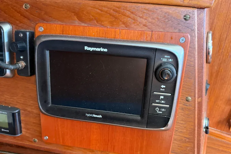 Acadia Yacht Photos Pics Raymarine display on 1997 Tartan 3800 sailboat, mounted on wooden panel.