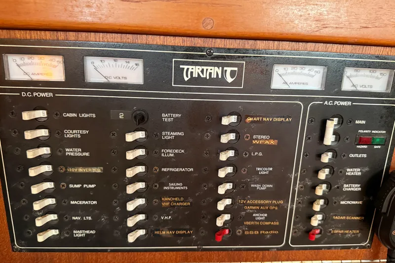 Acadia Yacht Photos Pics 1997 Tartan 3800 control panel with switches and gauges for DC and AC power management.