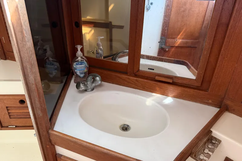 Acadia Yacht Photos Pics Bathroom sink area in a 1997 Tartan 3800 yacht with wooden cabinetry.