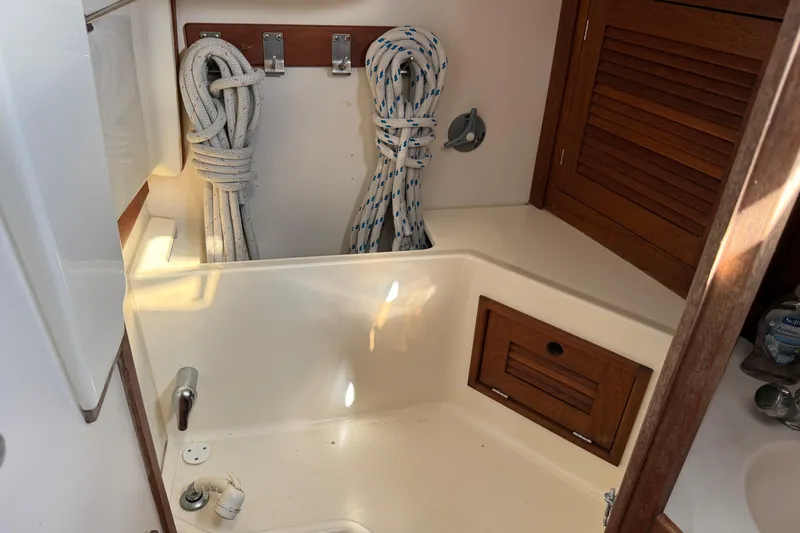 Acadia Yacht Photos Pics Interior of 1997 Tartan 3800 sailboat with ropes and wooden storage.