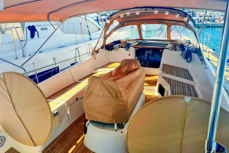  Yacht Photos Pics 2009 Jeanneau Sun Odyssey 50 DS yacht cockpit with covered seating and wooden deck.